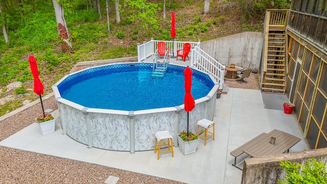 7751 W Old Barclay Creek Ln, Columbia, MO 65202 - view of swimming pool featuring stairs, a deck, and a patio area