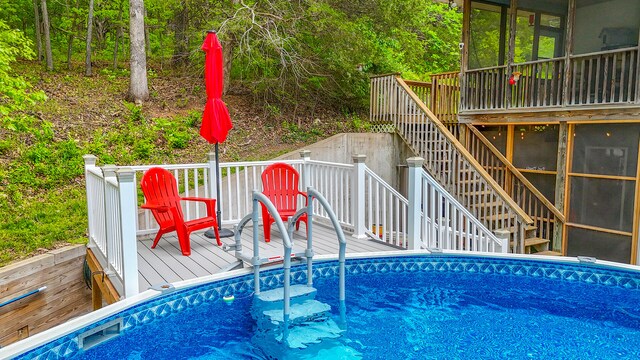 7751 W Old Barclay Creek Ln, Columbia, MO 65202 - swimming pool with stairs, a deck, and a sunroom