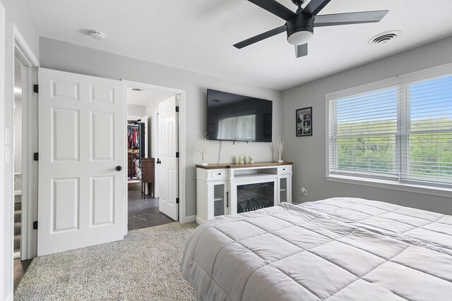 7751 W Old Barclay Creek Ln, Columbia, MO 65202 - bedroom featuring a spacious closet, carpet, ceiling fan, baseboards, and a textured ceiling