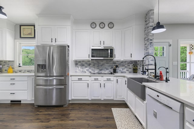 7751 W Old Barclay Creek Ln, Columbia, MO 65202 - kitchen featuring appliances with stainless steel finishes, a sink, dark wood-style flooring, light countertops, and decorative backsplash