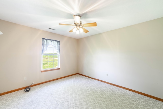 12421 Lang Rd, Boonville, MO 65233 - spare room featuring baseboards, a ceiling fan, and light carpet