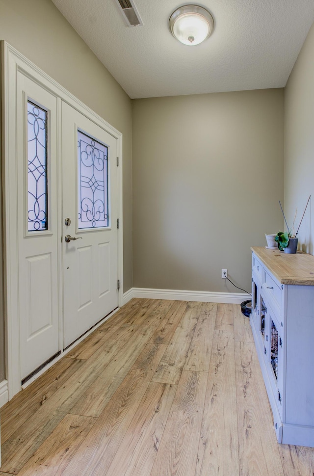 1600 Andretti Cir, Columbia, MO 65201 - entryway featuring light wood-type flooring, baseboards, and a textured ceiling