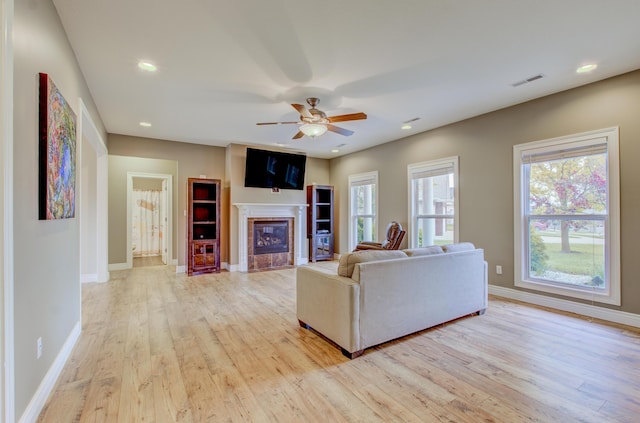 1600 Andretti Cir, Columbia, MO 65201 - living area with light wood-style floors, baseboards, a ceiling fan, a tiled fireplace, and recessed lighting