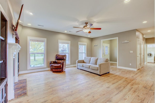 1600 Andretti Cir, Columbia, MO 65201 - living area with washer / clothes dryer, a fireplace, light wood-type flooring, a ceiling fan, and baseboards