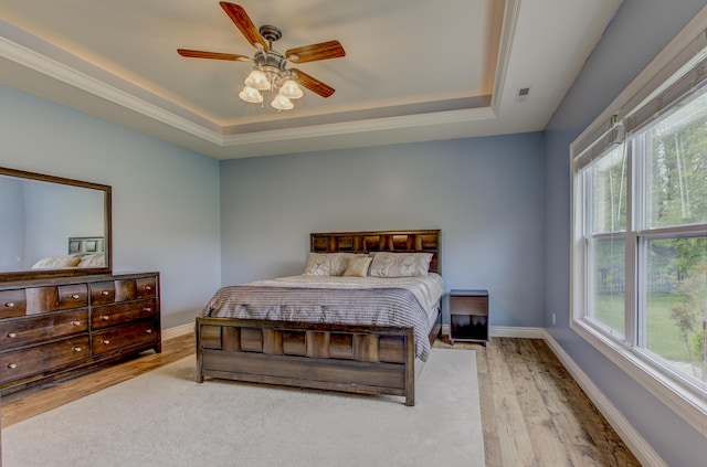 1600 Andretti Cir, Columbia, MO 65201 - bedroom featuring a raised ceiling, wood finished floors, baseboards, and ceiling fan
