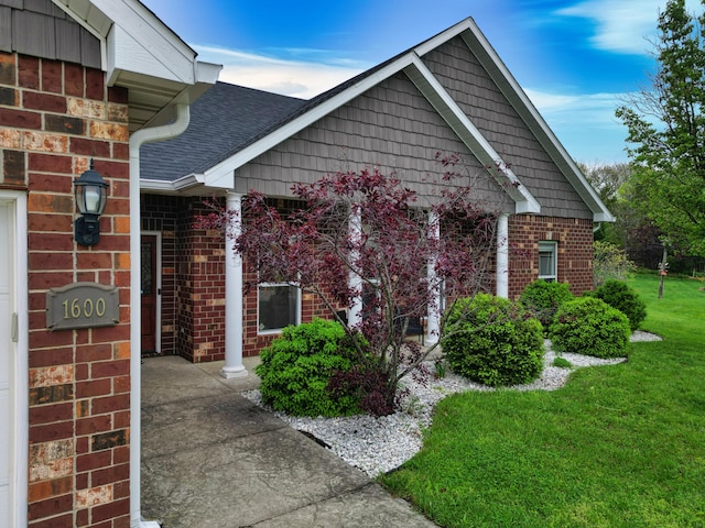 1600 Andretti Cir, Columbia, MO 65201 - view of front of property with brick siding, a front lawn, and a shingled roof