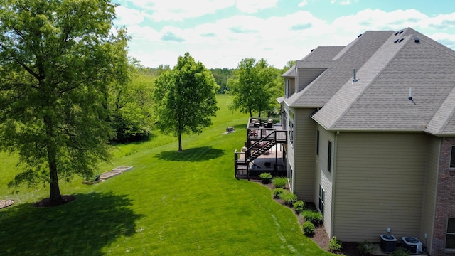 6507 Crooked Switch Ct, Columbia, MO 65201 - view of grassy yard featuring stairs, cooling unit, and a deck