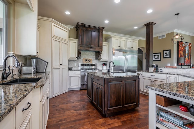 6507 Crooked Switch Ct, Columbia, MO 65201 - kitchen featuring appliances with stainless steel finishes, a sink, dark stone counters, dark brown cabinetry, and ornamental molding