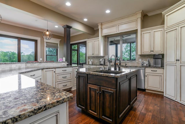 6507 Crooked Switch Ct, Columbia, MO 65201 - kitchen featuring a sink, cream cabinetry, ornamental molding, backsplash, and recessed lighting
