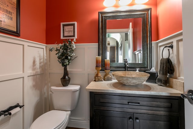 6507 Crooked Switch Ct, Columbia, MO 65201 - half bathroom with a decorative wall, wainscoting, toilet, and vanity