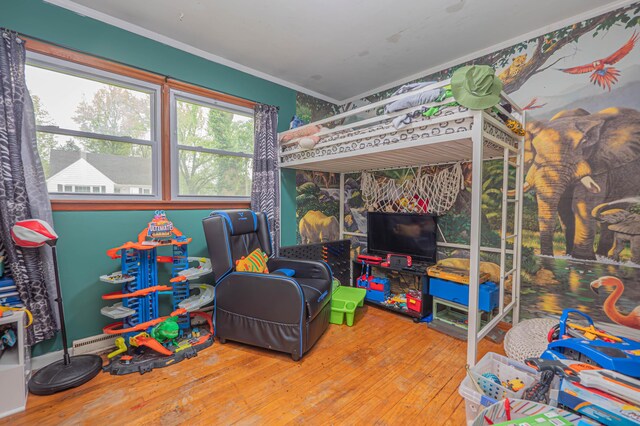 bedroom featuring crown molding and hardwood / wood-style flooring