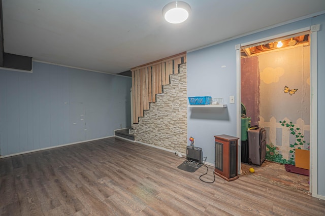 living area with baseboards, stairs, and wood finished floors