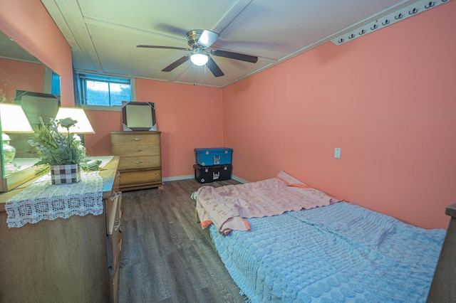 bedroom featuring a ceiling fan, baseboards, and dark wood-type flooring