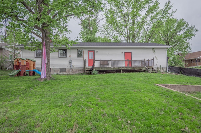 rear view of property featuring a yard and a wooden deck
