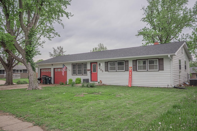ranch-style home featuring a garage, a chimney, driveway, and a front lawn