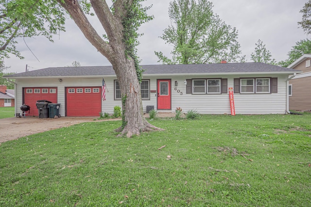 single story home featuring an attached garage, driveway, and a front yard
