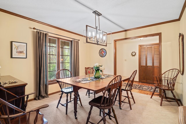 dining area featuring an inviting chandelier, ornamental molding, baseboards, and light wood-style flooring