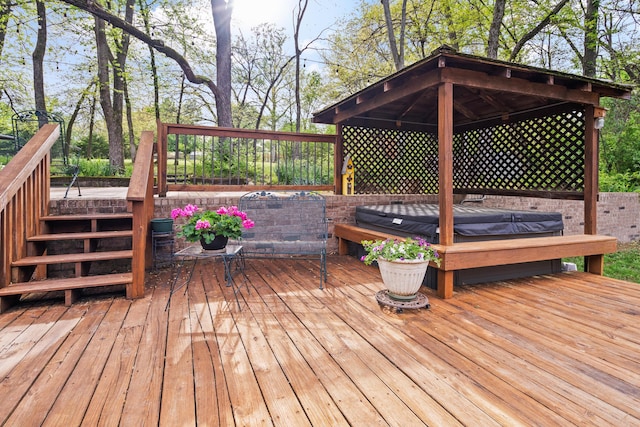 wooden deck featuring a covered hot tub