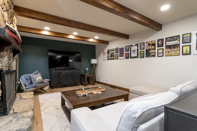 living area with recessed lighting, light wood-type flooring, beam ceiling, and a fireplace