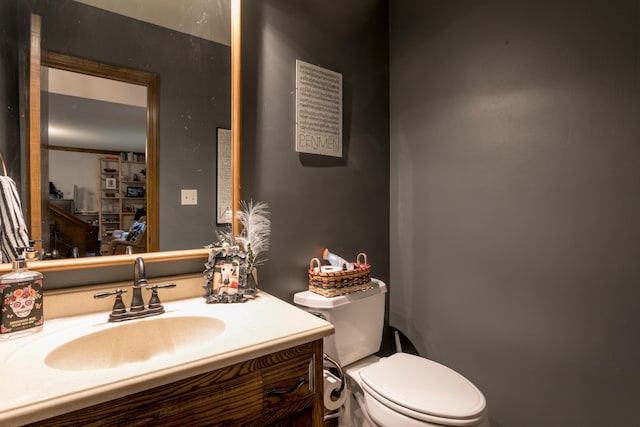 bathroom featuring toilet and vanity