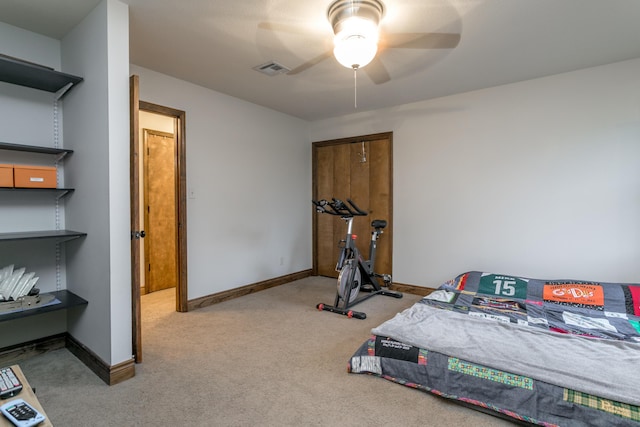 carpeted bedroom featuring baseboards, a ceiling fan, and visible vents