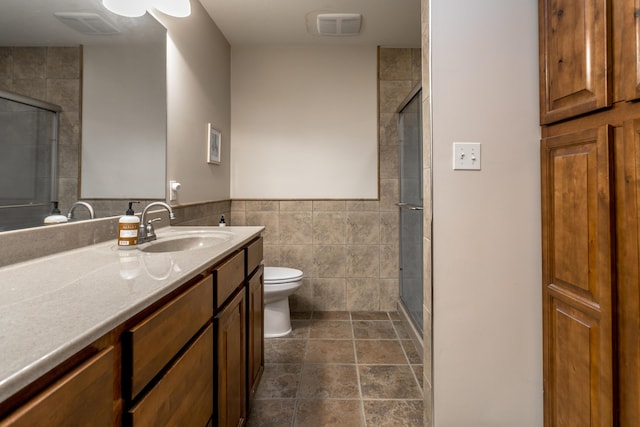 full bath with vanity, toilet, and a shower stall