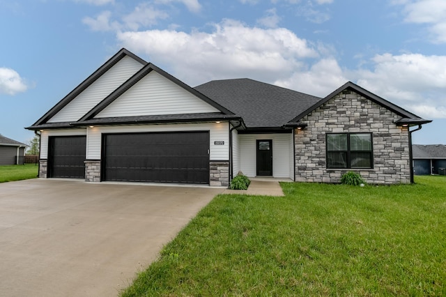 15070 Ada Dr, Hallsville, MO 65255 - view of front facade featuring a shingled roof, stone siding, a garage, a front yard, and concrete driveway