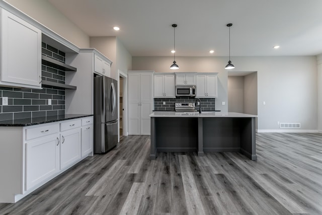 15070 Ada Dr, Hallsville, MO 65255 - kitchen with open shelves, appliances with stainless steel finishes, light wood-style flooring, and visible vents