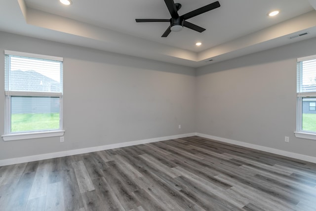 15070 Ada Dr, Hallsville, MO 65255 - empty room with ceiling fan, visible vents, wood finished floors, a raised ceiling, and recessed lighting