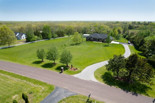 birds eye view of property with a view of trees and a rural view