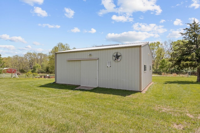 view of pole building with fence and a yard