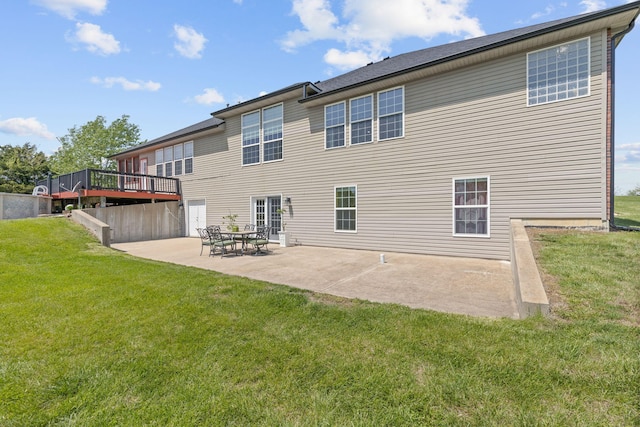 rear view of property with a lawn, a patio, and a deck
