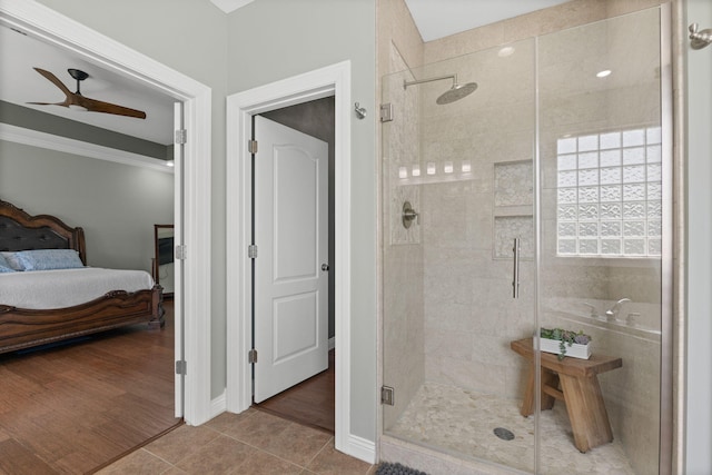 bathroom featuring ceiling fan, a shower stall, ensuite bathroom, and tile patterned flooring