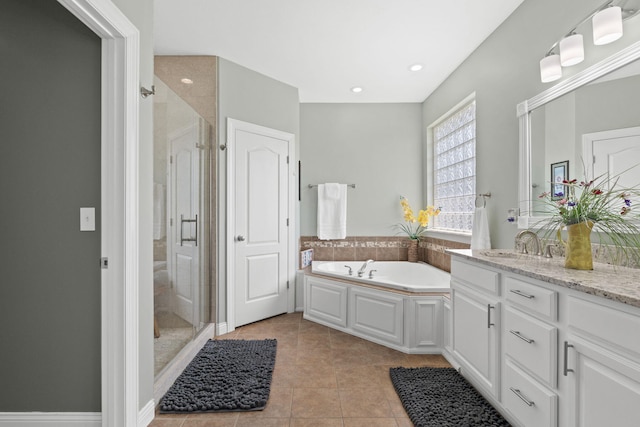 full bathroom featuring vanity, tile patterned flooring, a stall shower, and a garden tub