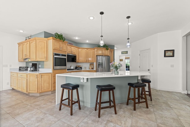 kitchen with light countertops, stainless steel appliances, a large island, and recessed lighting