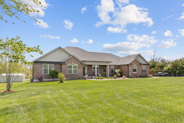 single story home with covered porch, a front yard, and brick siding