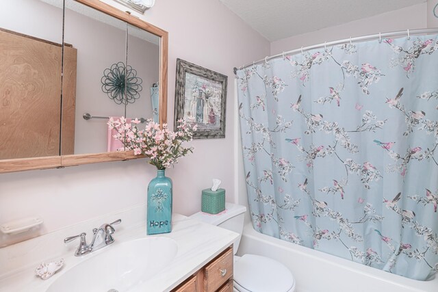 full bath featuring toilet, shower / bath combination with curtain, and vanity