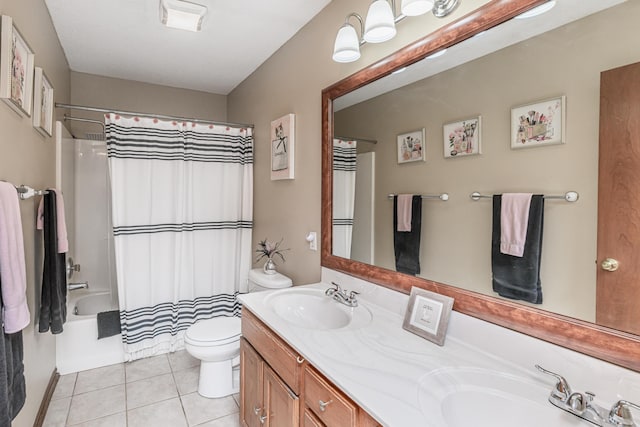 full bathroom with double vanity, toilet, tile patterned floors, and a sink