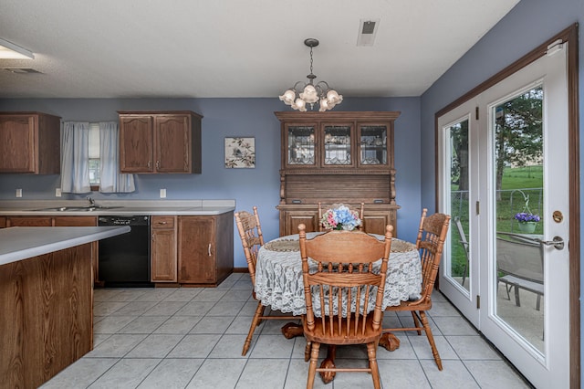 dining room with light tile patterned floors, a chandelier, and a healthy amount of sunlight