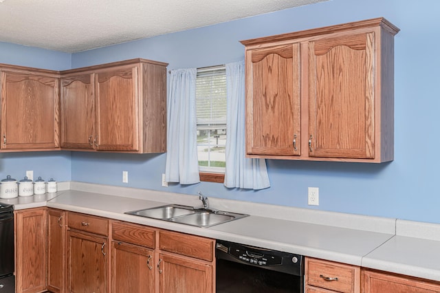 kitchen featuring a sink, light countertops, a textured ceiling, stove, and black dishwasher