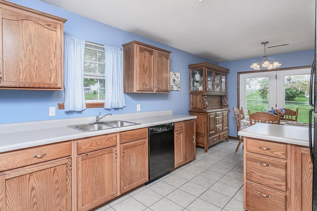 kitchen with black dishwasher, a wealth of natural light, a sink, and light countertops