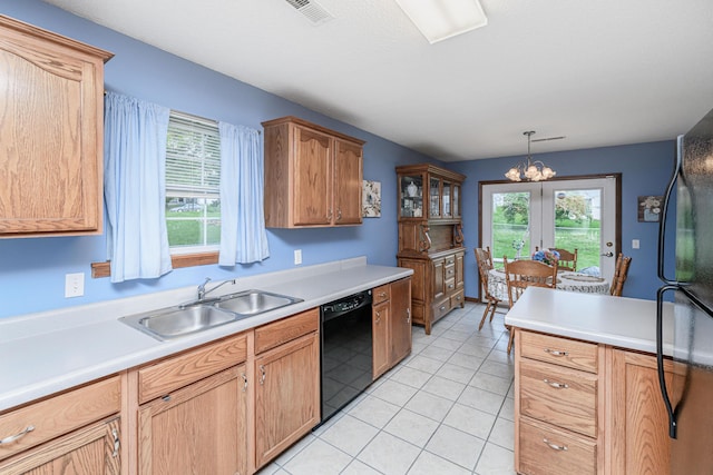 kitchen featuring visible vents, a sink, black appliances, and light countertops