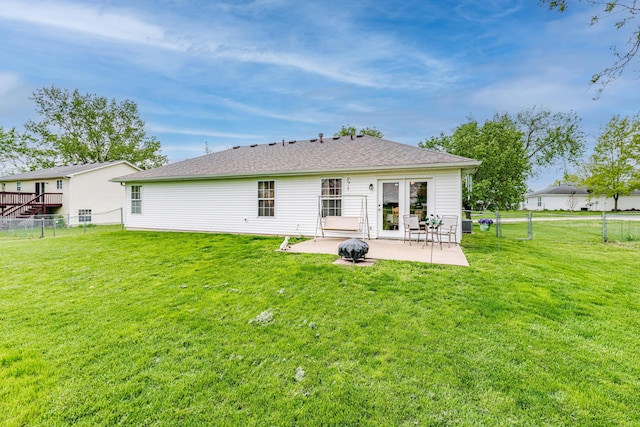 back of property featuring a lawn, a fenced backyard, and a patio area