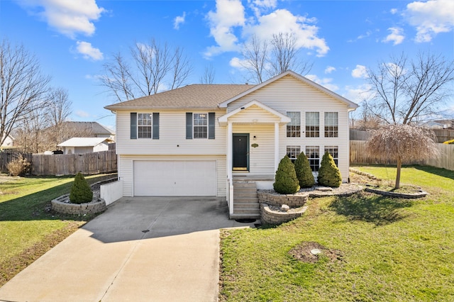 5650 N Autumn Dr, Columbia, MO 65202 - bi-level home featuring driveway, roof with shingles, fence, a front lawn, and an attached garage