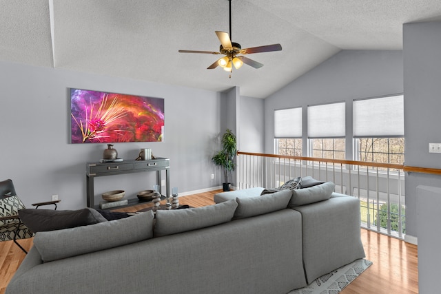 5650 N Autumn Dr, Columbia, MO 65202 - living room featuring ceiling fan, a textured ceiling, high vaulted ceiling, baseboards, and wood finished floors