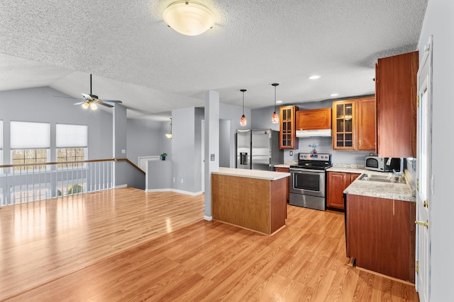 5650 N Autumn Dr, Columbia, MO 65202 - kitchen with a ceiling fan, stainless steel appliances, brown cabinets, and a textured ceiling