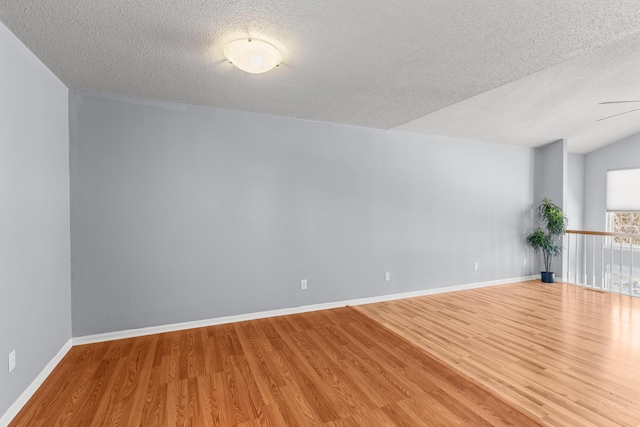 5650 N Autumn Dr, Columbia, MO 65202 - spare room with baseboards, a textured ceiling, and wood finished floors