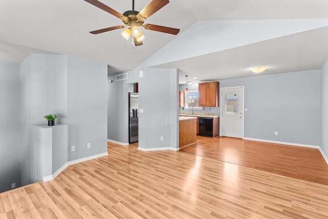 5650 N Autumn Dr, Columbia, MO 65202 - unfurnished living room with a ceiling fan, baseboards, visible vents, and light wood-style flooring