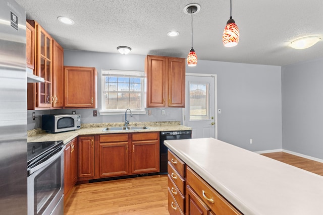 5650 N Autumn Dr, Columbia, MO 65202 - kitchen featuring a sink, dishwasher, light countertops, stainless steel range with electric stovetop, and a textured ceiling