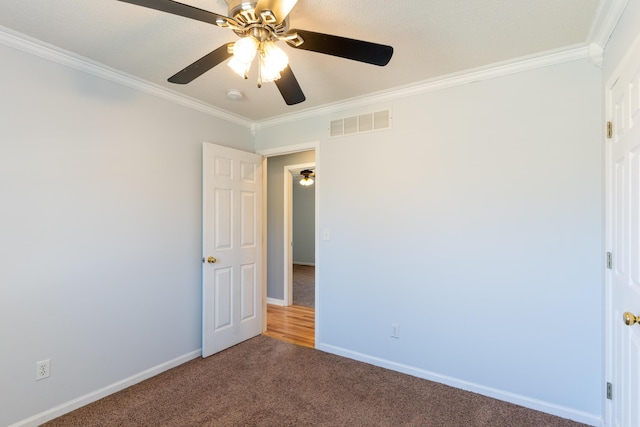 5650 N Autumn Dr, Columbia, MO 65202 - carpeted spare room featuring visible vents, ornamental molding, baseboards, and ceiling fan